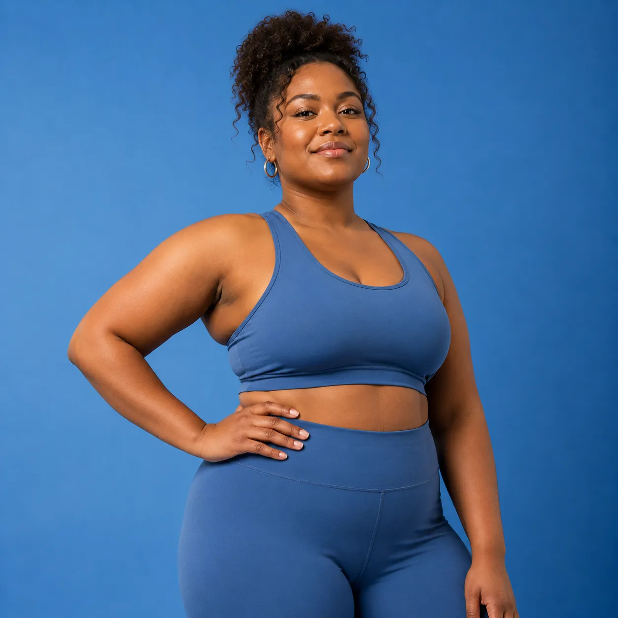 Woman wearing blue activewear with her arms crossed